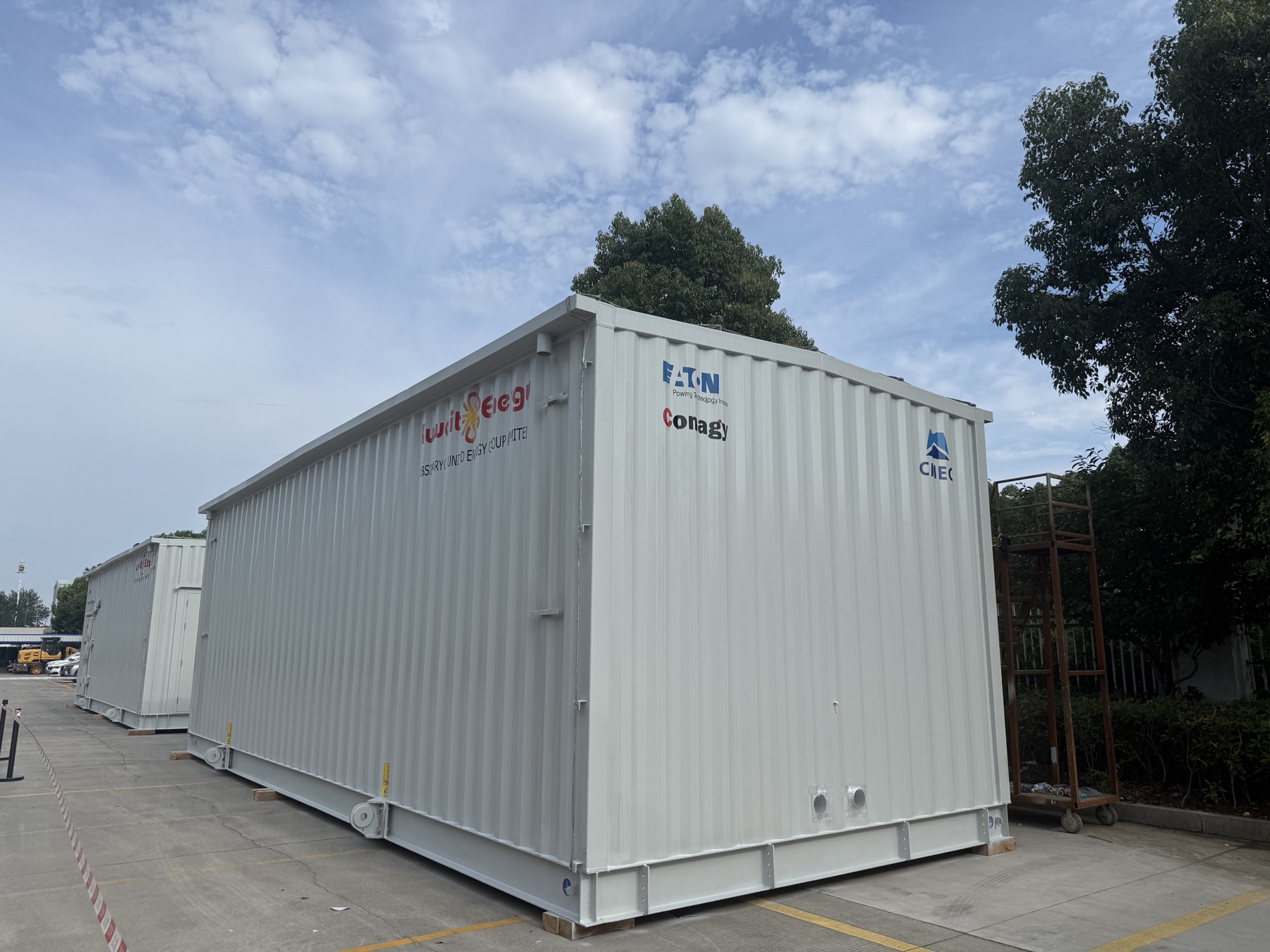 Completed E-House modules staged outside the factory