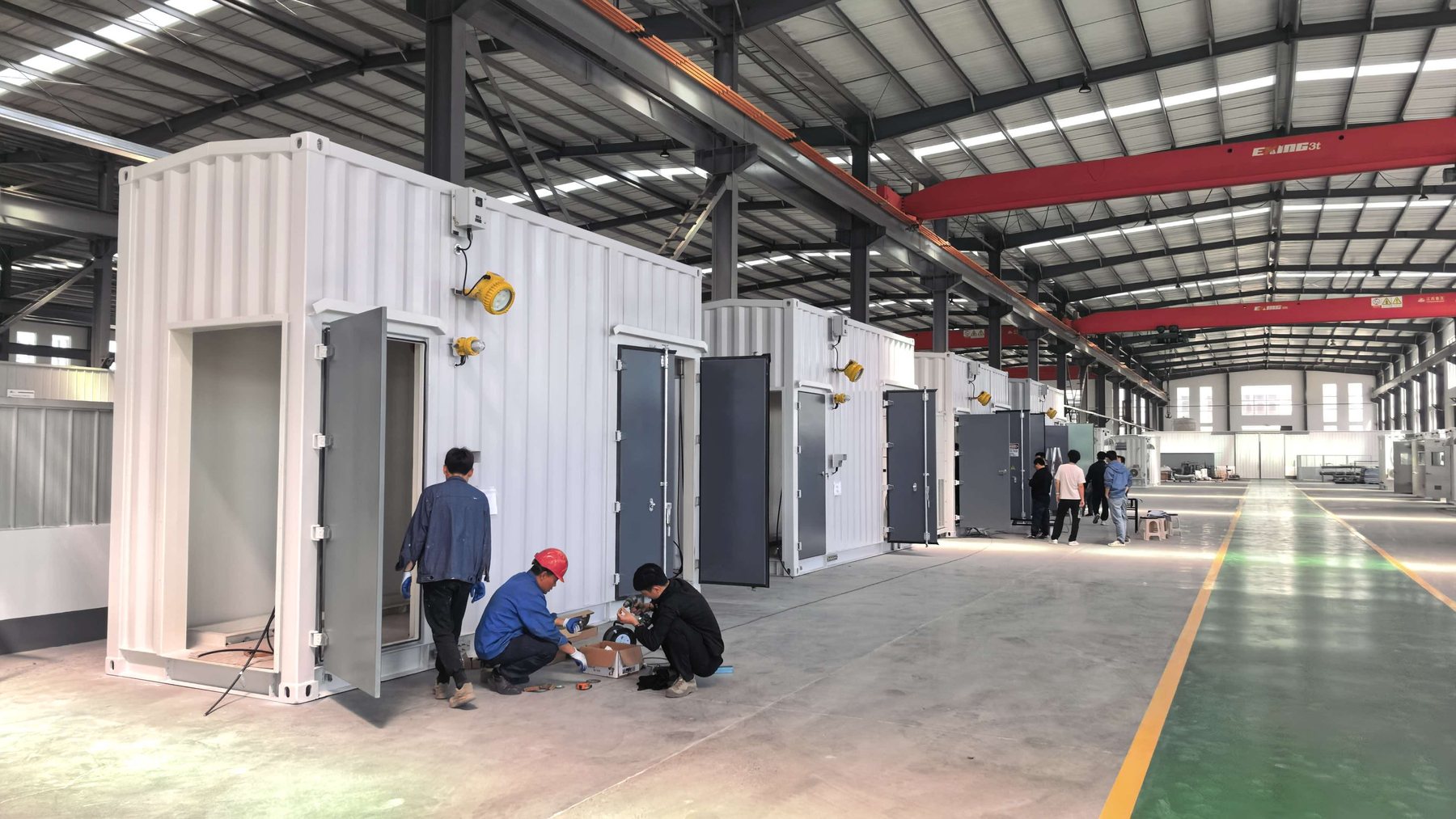 Factory integration row of E-House modules under assembly