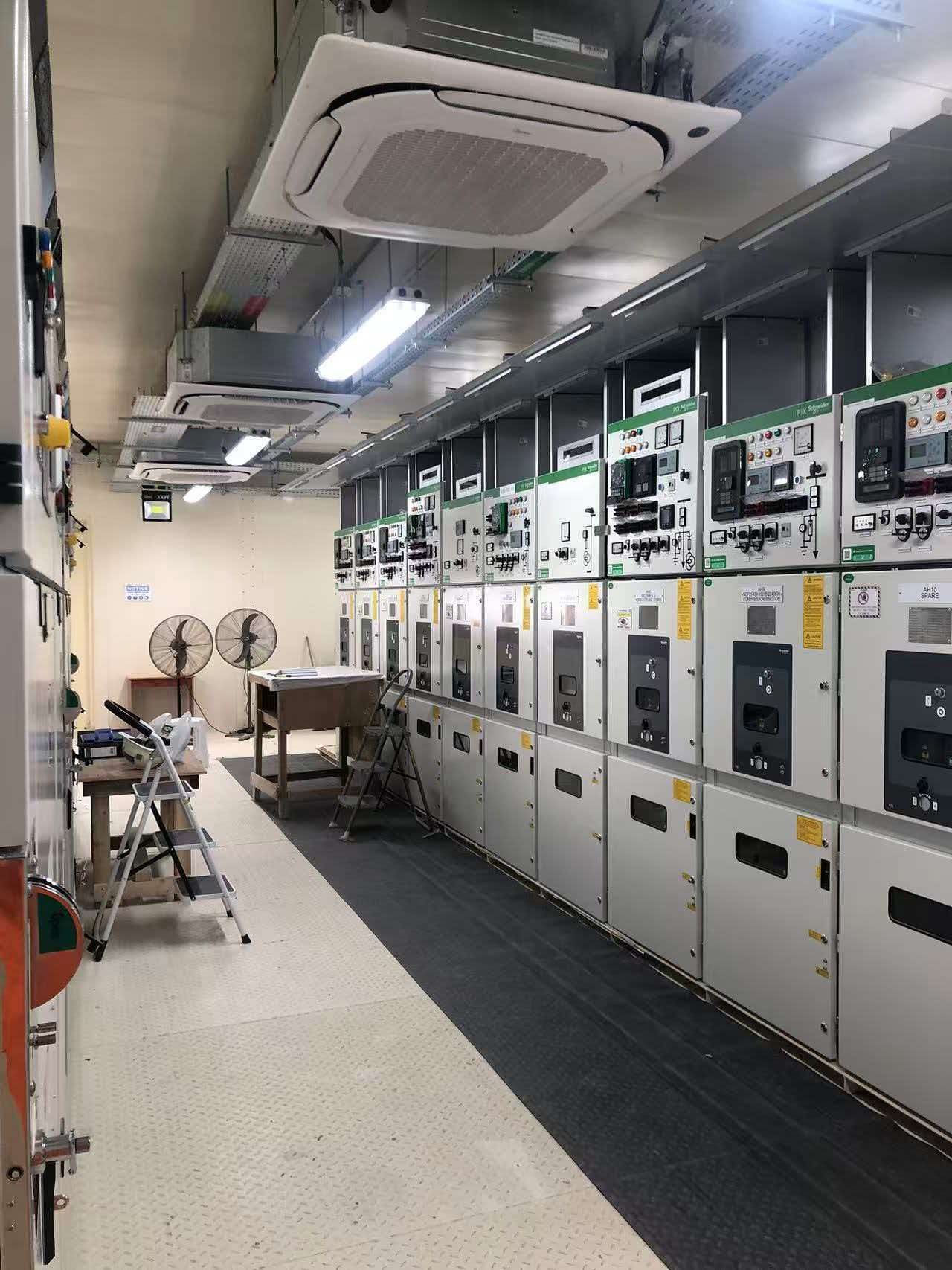 MV switchgear room with HVAC and aligned electrical panels inside an E-House